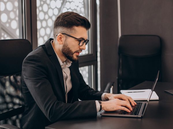 Handsome business man working on computer